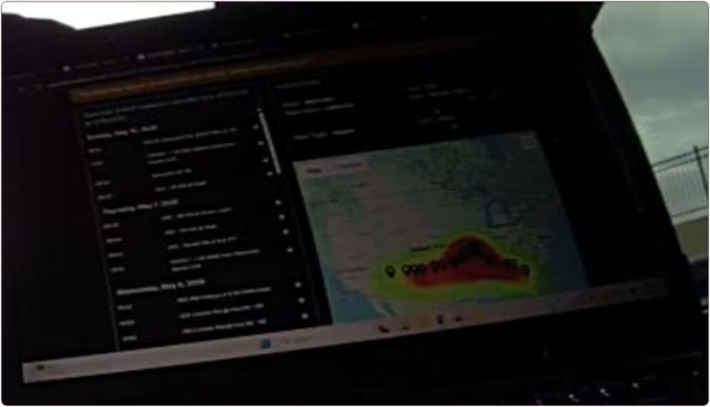 A blurry bodycam photo of a patrol-car laptop: on the left, a list of plate-reader sightings grouped by date; on the right, a map of the southern United States with a heat-map band and pins along the car's route.